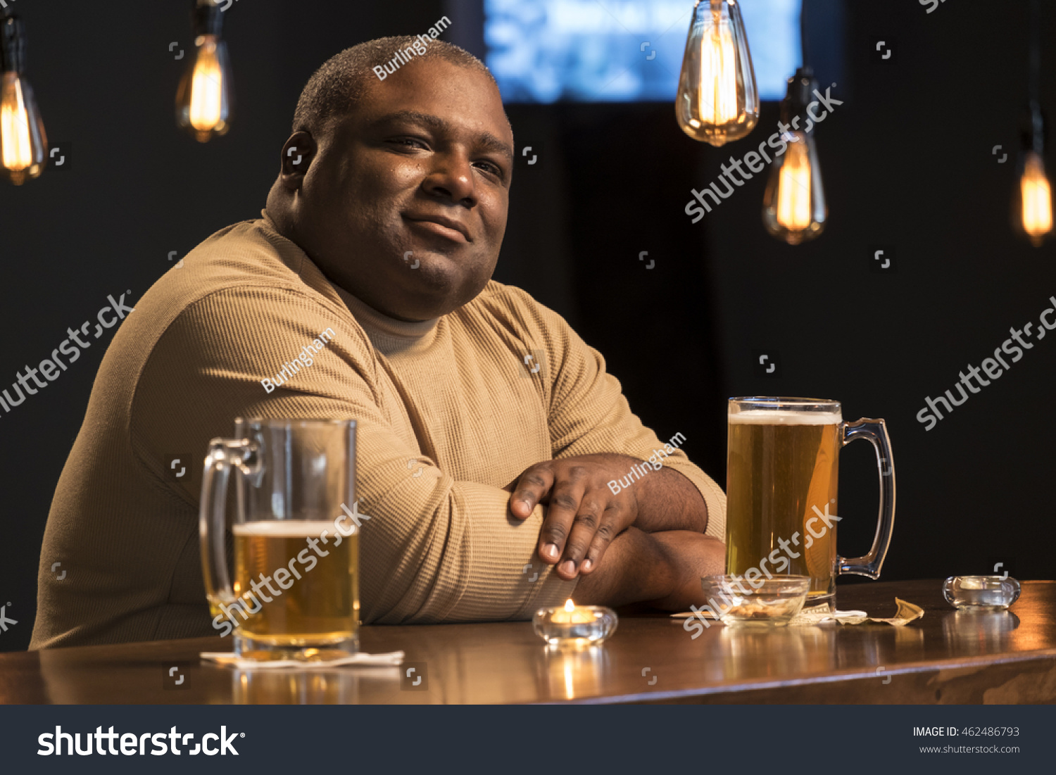stock-photo-portrait-of-a-guy-sitting-alone-at-a-bar-462486793.jpg